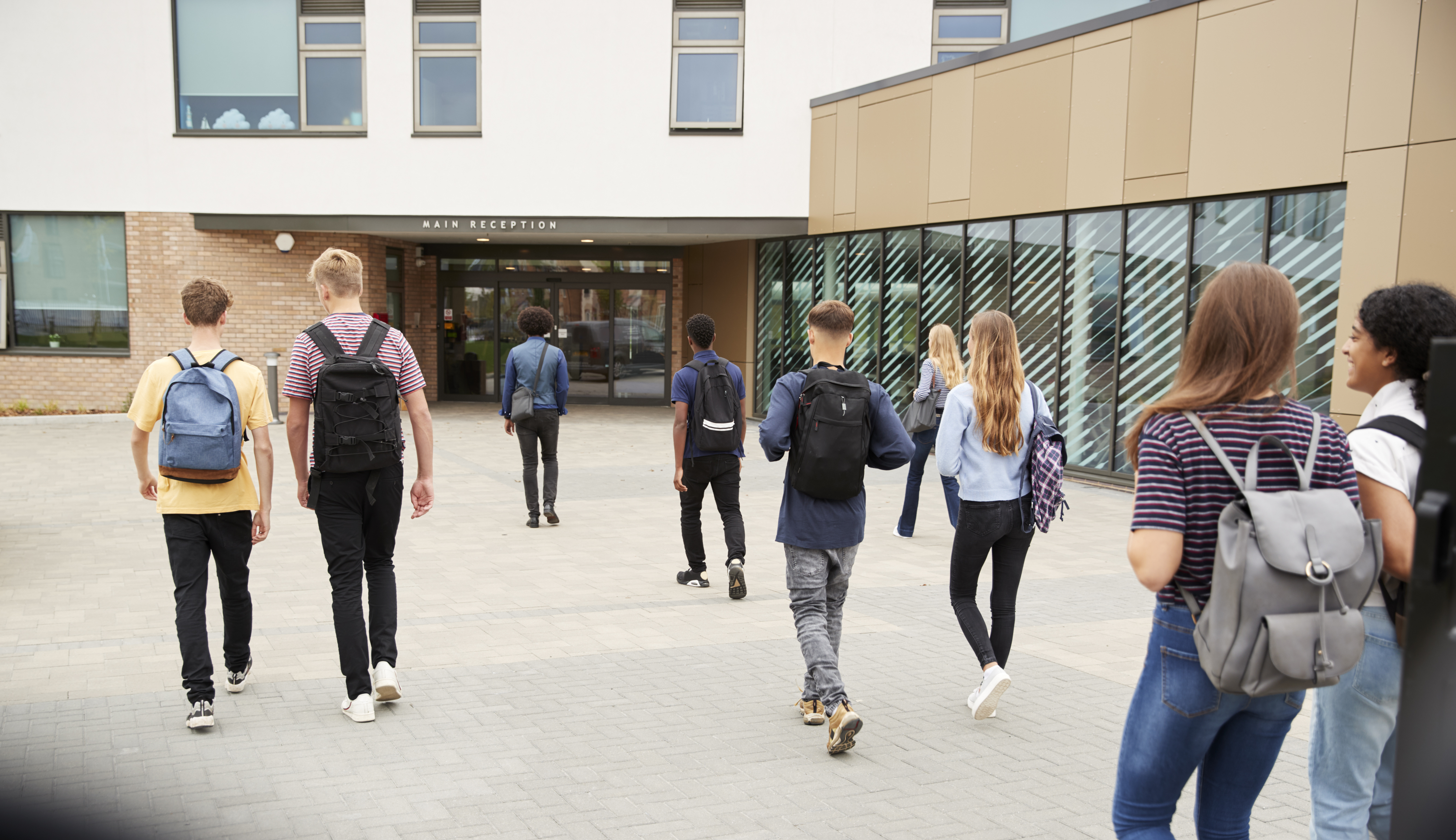 teenagers walking into school