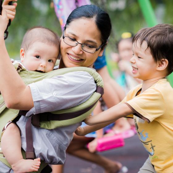 mother with kids on swings