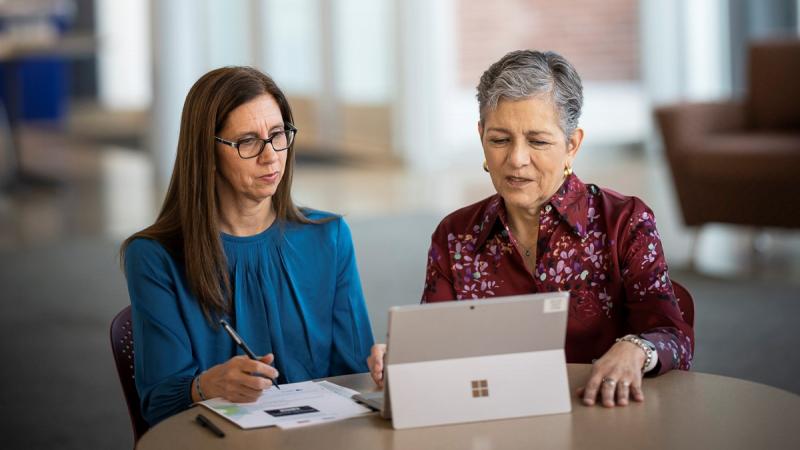 Photo of Dolores Acevedo-Garcia and Pamela Joshi working together at a tablet