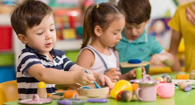 kids engaged in pretend kitchen play